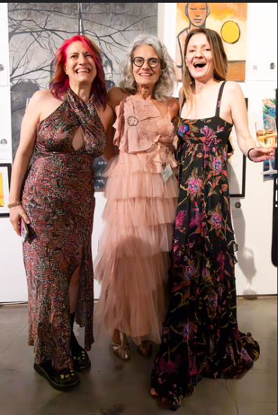 Three members dressed up and laughing together at a gala