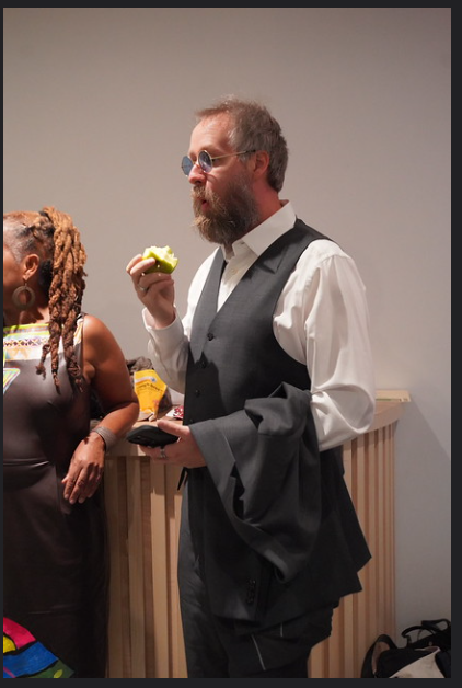 Photo of Dominik eating an apple at the gala