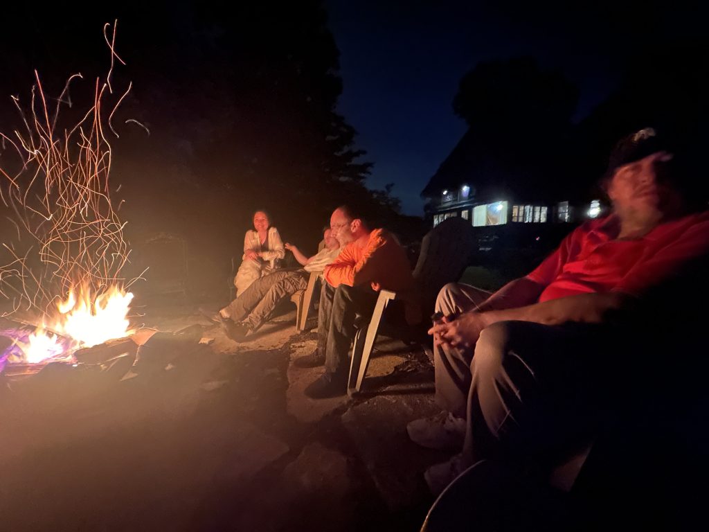 Members sharing an evening around a fire